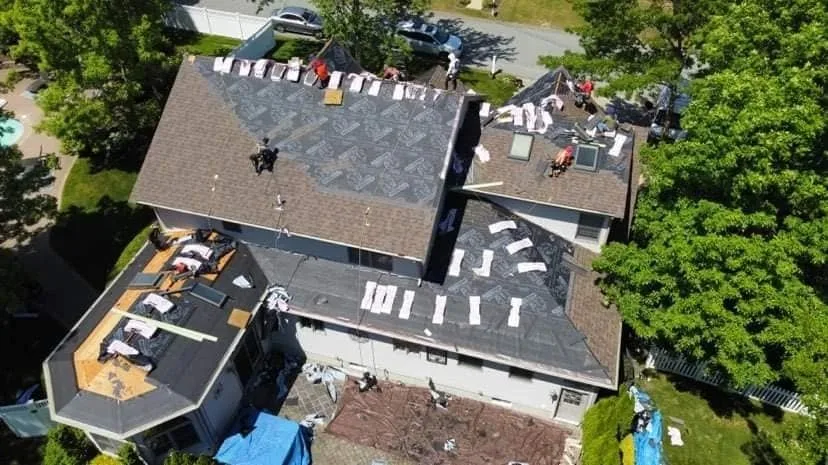 Aerial view of a house with the old roof stripped and new underlayment going down